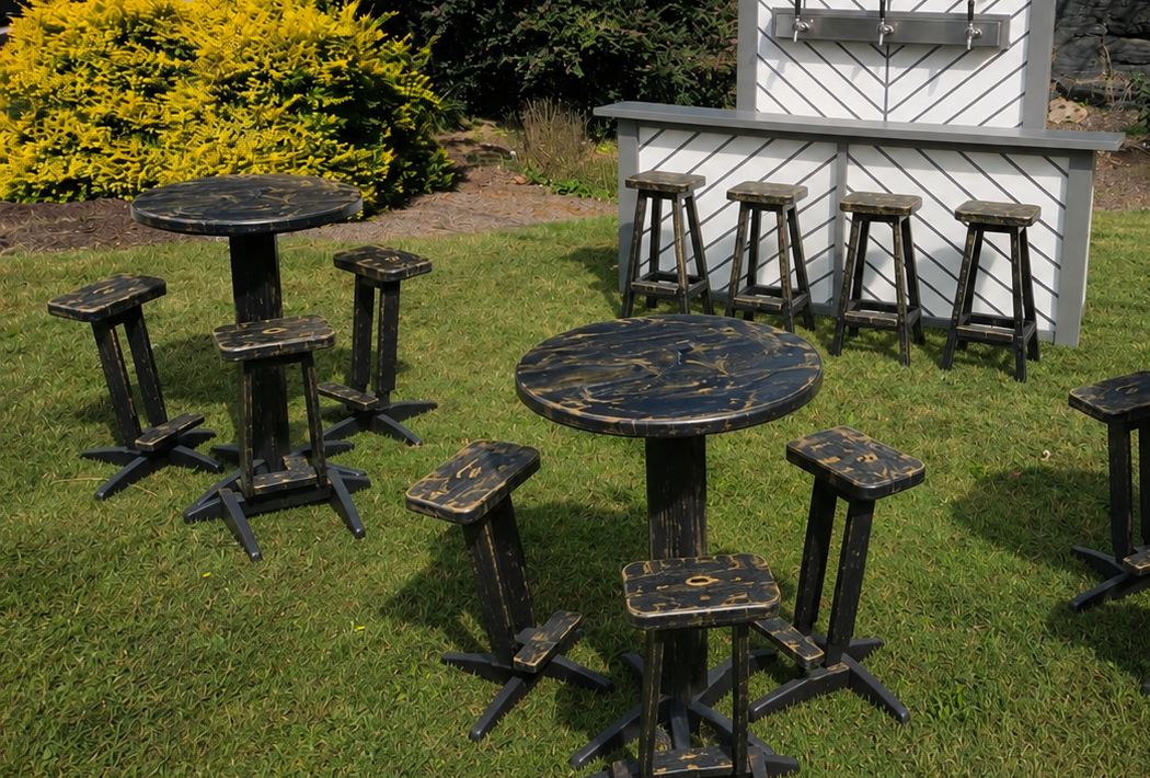 Black-and-gold cocktail tables on grass